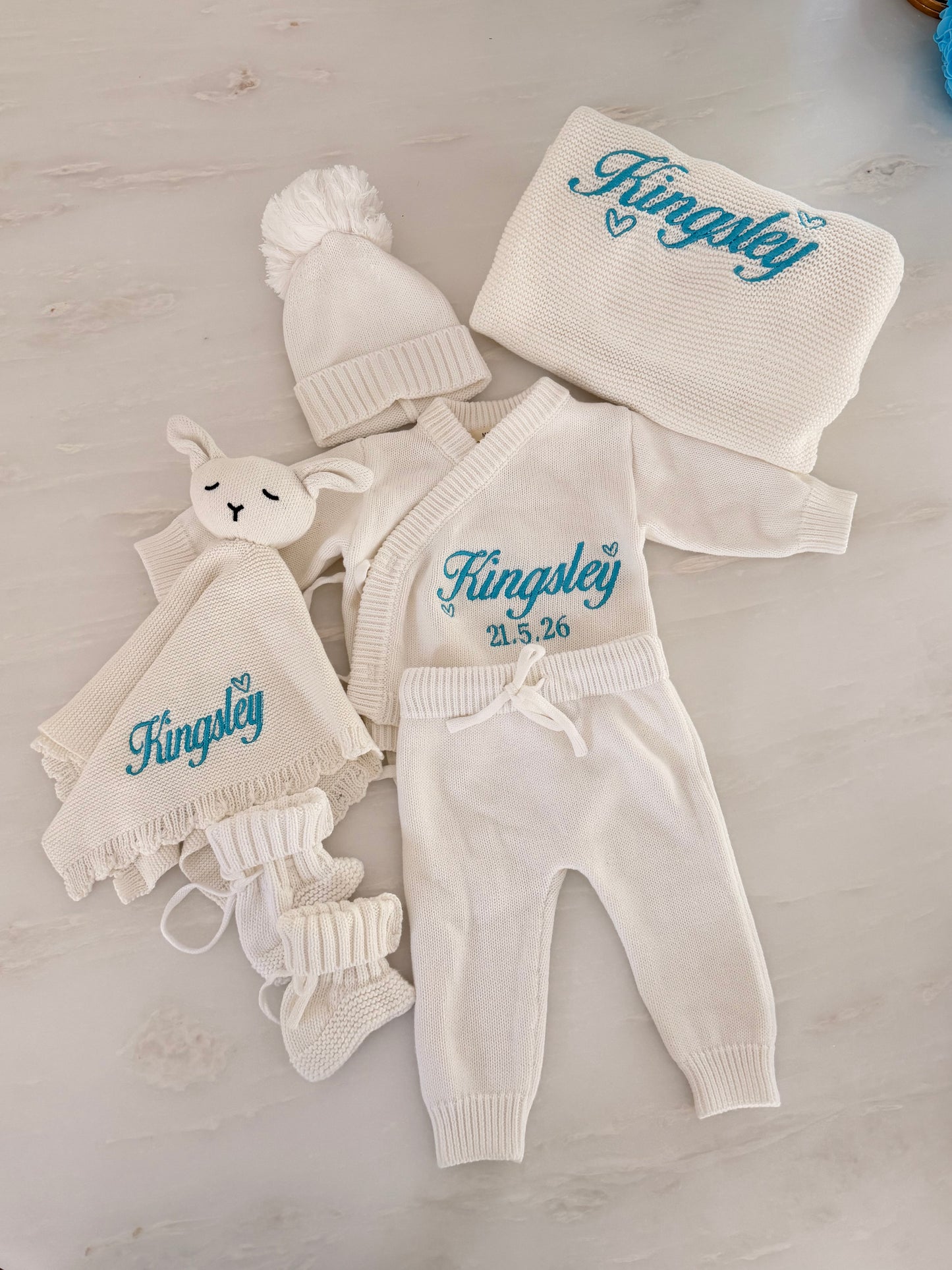 Personalised knit baby blanket and bunny comforter embroidered with baby’s name in blue thread