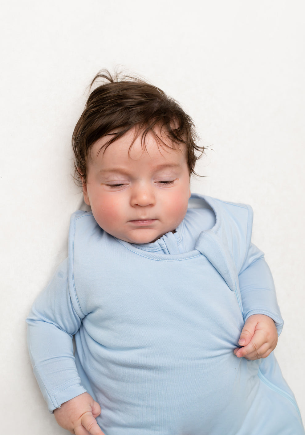     Minimalist pastel blue baby sleeping bag with padded bottom and sleeveless style for newborns and toddlers