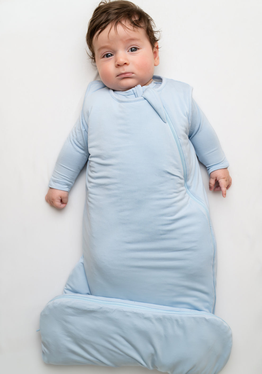     Soft blue wearable baby blanket designed for safe and comfortable infant sleep.