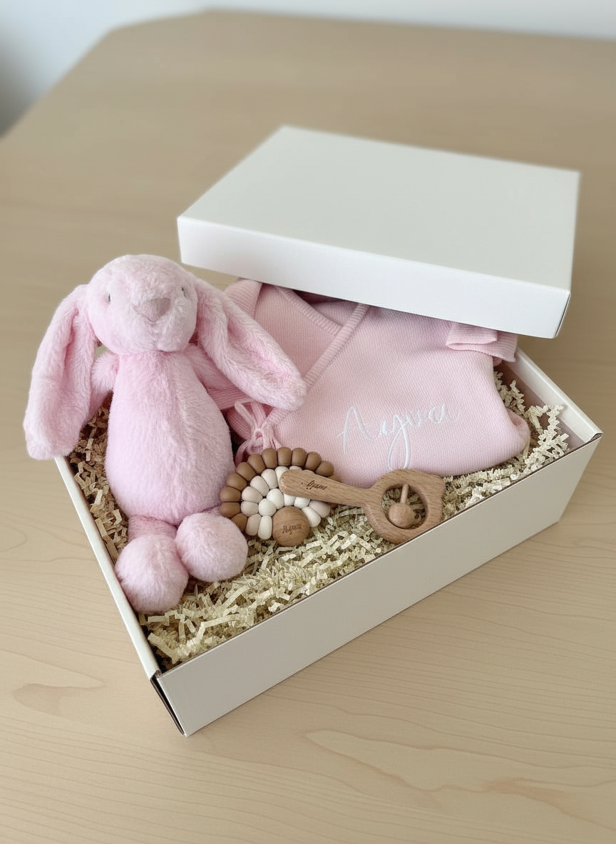 Pink personalised baby girl gift box with plush bunny, wrap romper, teether & rattle. Beautiful Aqiqah & shower gift. Free Dubai delivery.
