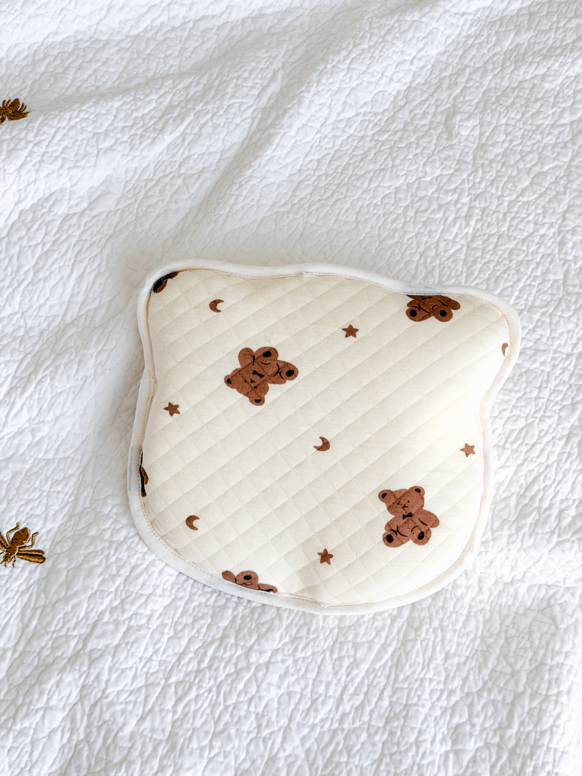 Quilted anti-flat-head baby pillow in cream with teddy bear, moon and stars print — gentle head shape support, included in Maxims baby store. Hello Little Cub gift box

