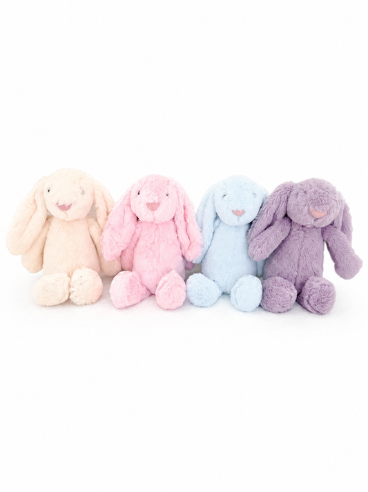Four Maxims plush baby bunnies sitting in a row showing pink, blue, cream and purple colour options — UAE baby gift
