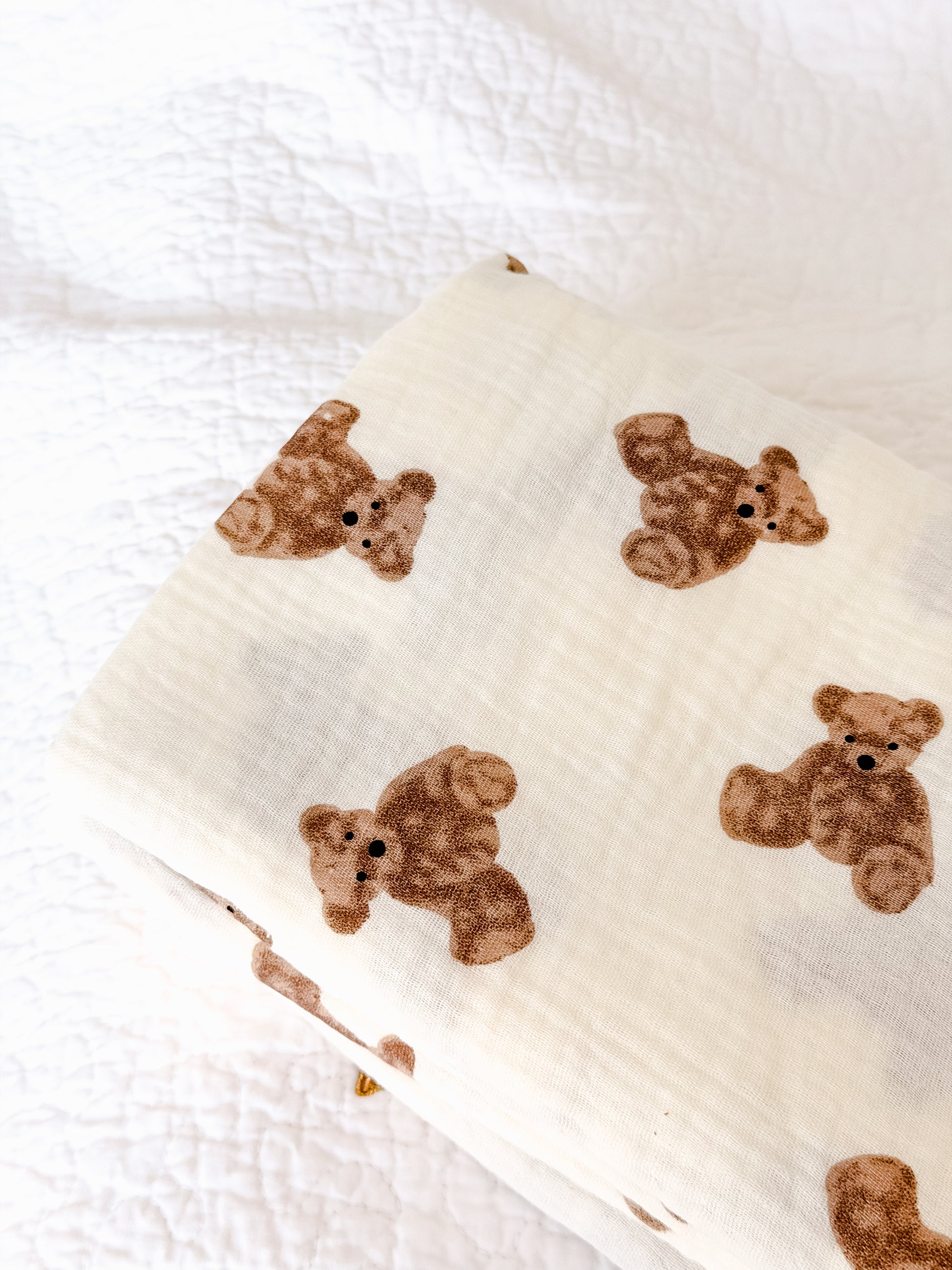 Cream muslin baby blanket spread flat showing soft double-layer cotton fabric with teddy bear print — perfect newborn swaddle in Dubai
