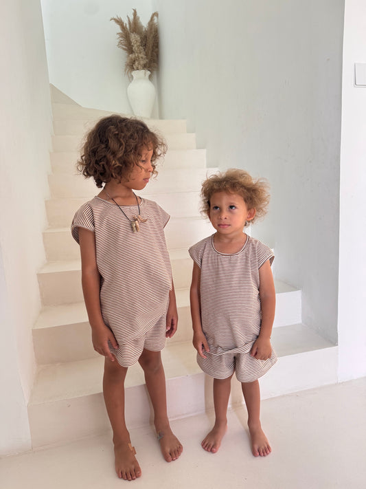 Child wearing a neutral stripe cotton short set made from 100% breathable cotton