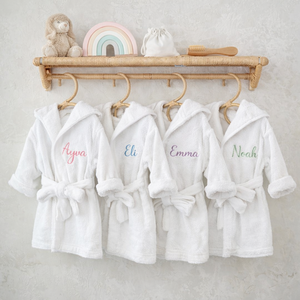 Personalised hooded baby bathrobes in organic cotton with embroidered names Ayva, Eli, Emma and Noah — Maxims Baby Store. Dubai UAE
