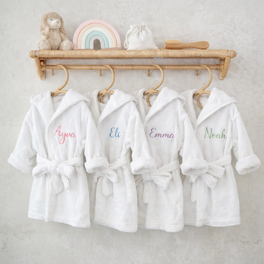 Personalised hooded baby bathrobes in organic cotton with embroidered names Ayva, Eli, Emma and Noah — Maxims Baby Store. Dubai UAE
