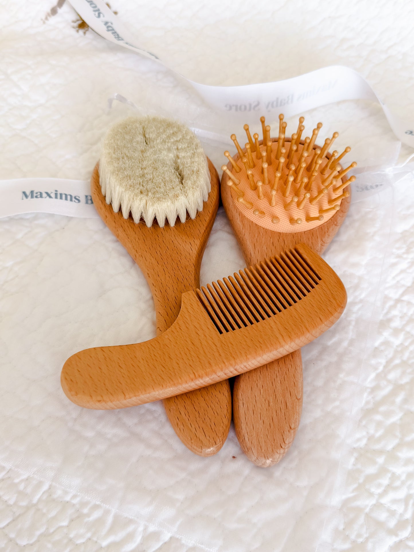 Wooden baby brush and comb set presented in organza gift pouch — perfect baby shower and Aqiqah gift in Dubai
