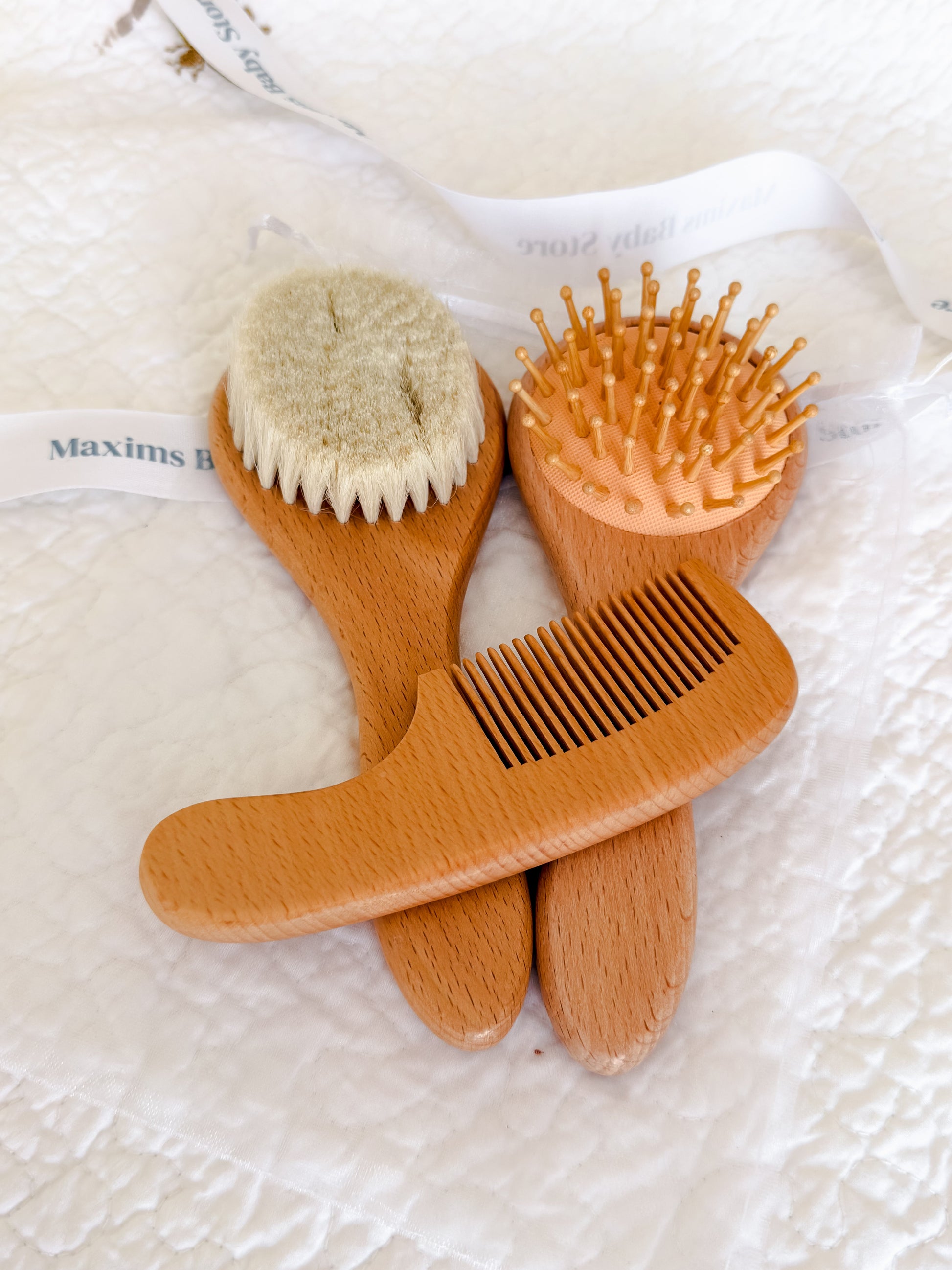 Wooden baby brush and comb set presented in organza gift pouch — perfect baby shower and Aqiqah gift in Dubai
