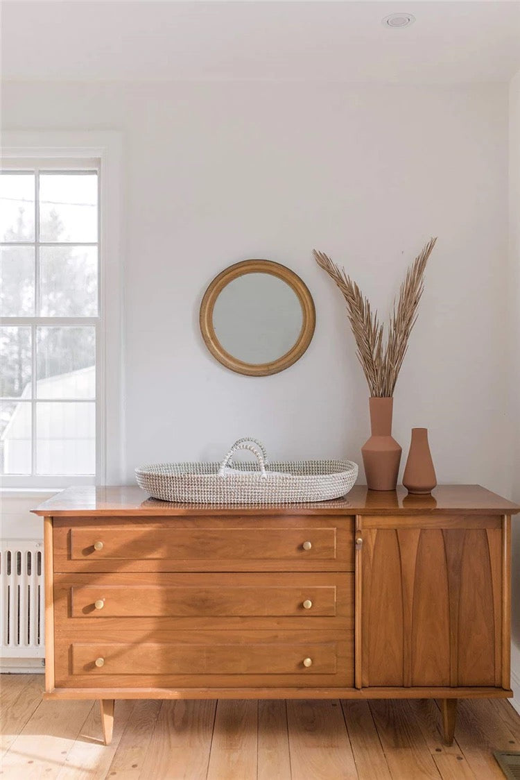 Minimalist baby Moses basket styled for neutral nursery decor